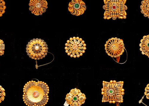 Gold subdued as trade optimism weighs, but soft dollar caps losses