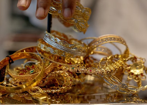 Gold inches lower as dollar gains, markets await Fed appointments